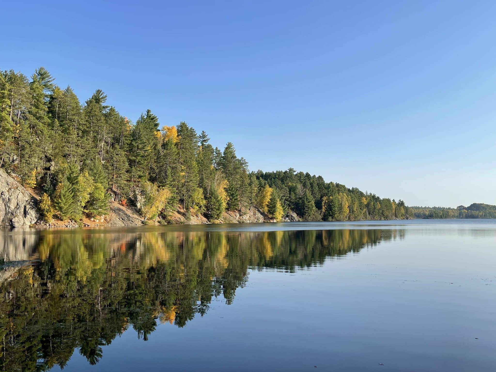 Still northern Minnesota lake, tree reflections