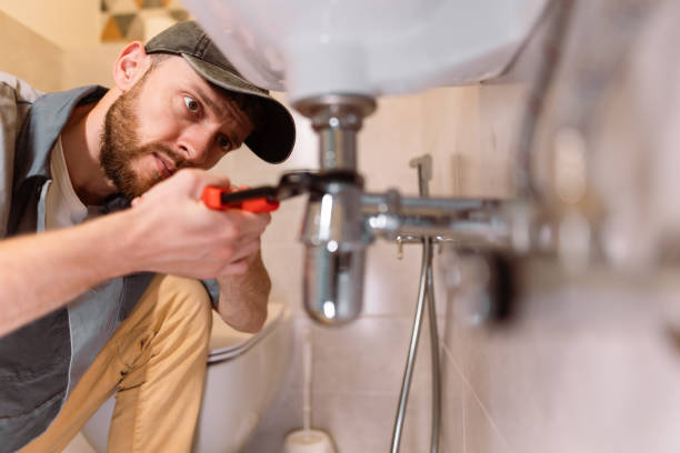 Plumber under bathroom sink